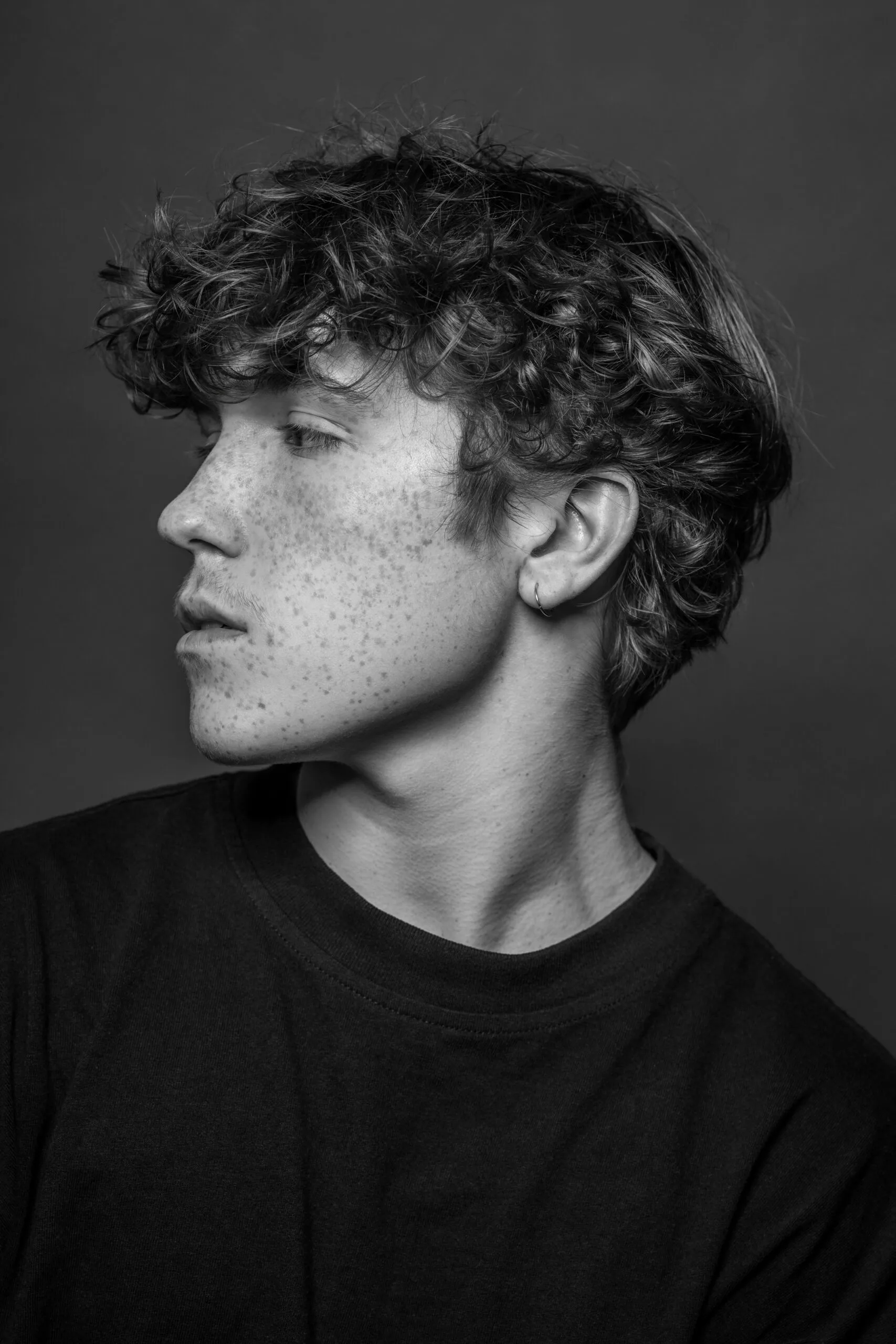 Photo portrait studio Montréal – jeune homme cheveux bouclés, noir et blanc